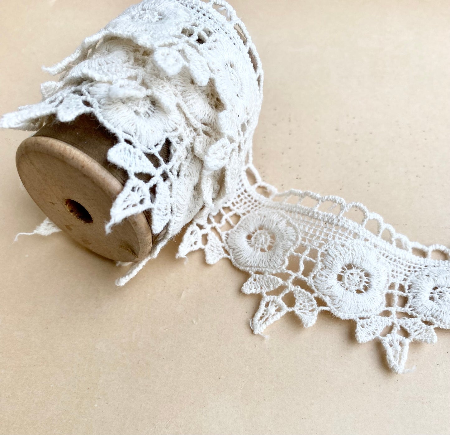 wooden vintage spool with rose lace.