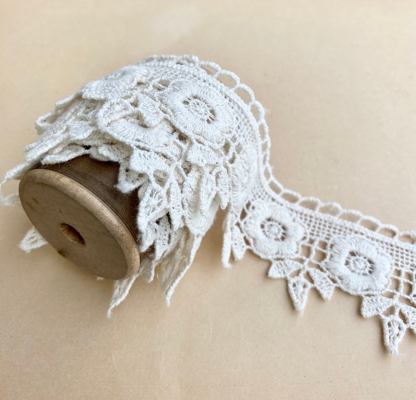 wooden vintage spool with rose lace.