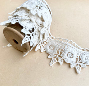 wooden  spool with rose lace.