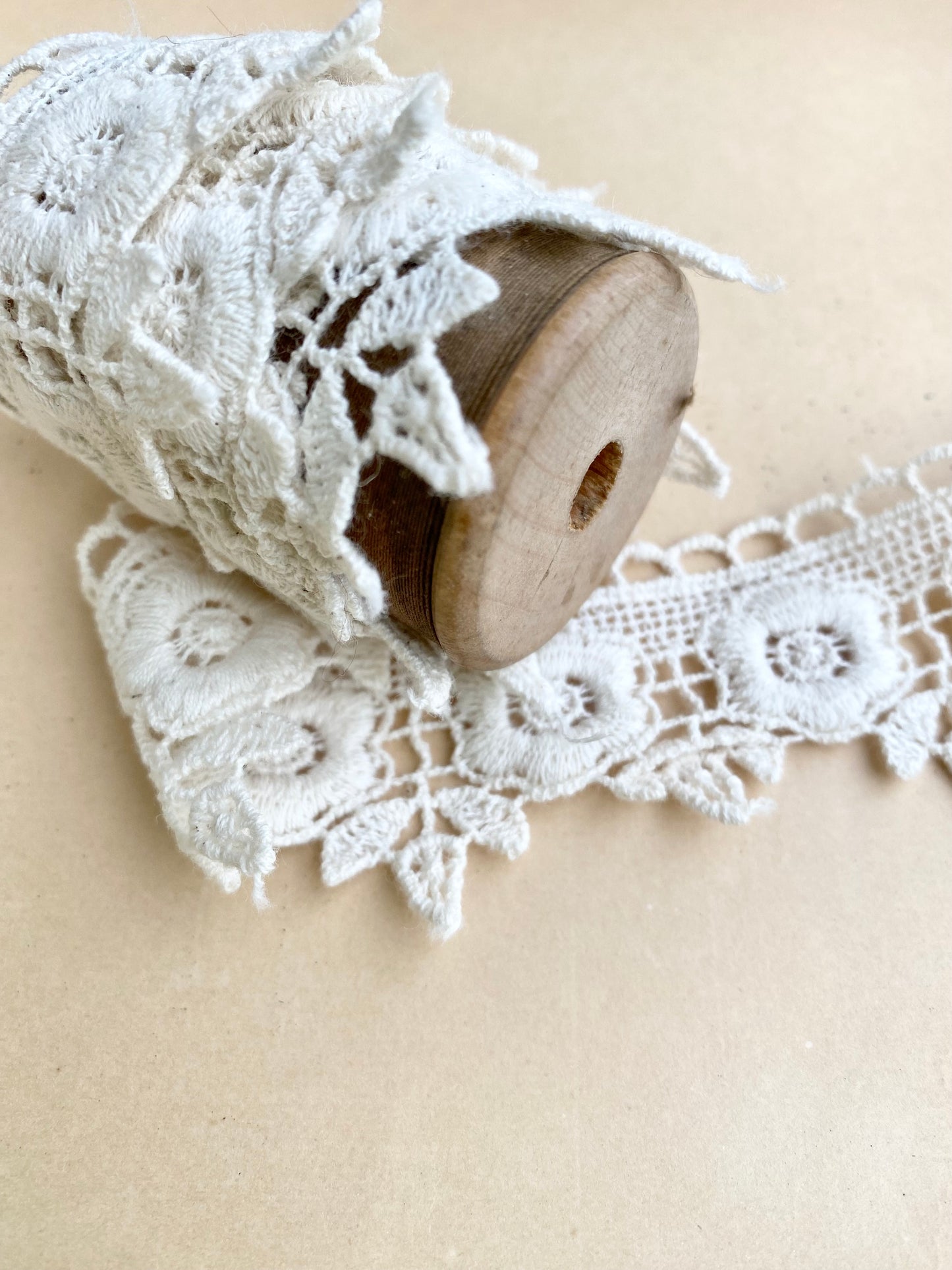 wooden vintage spool with rose lace.
