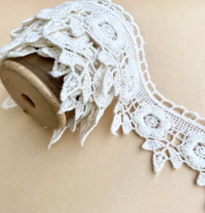 wooden  spool with rose lace.