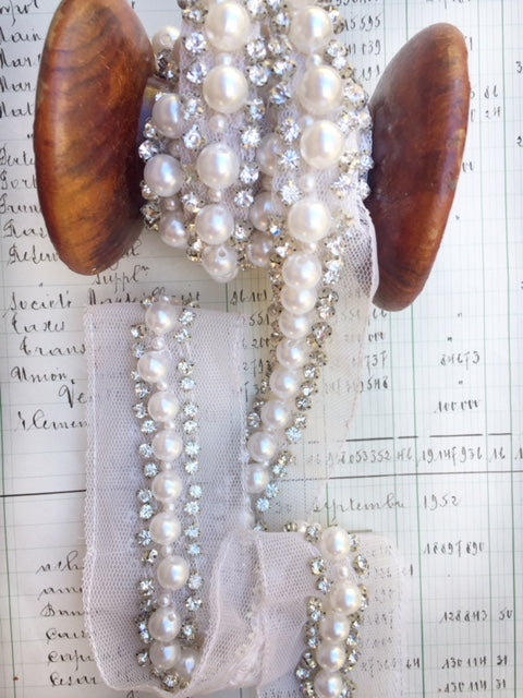 Pearl and rhinestone trim on net.