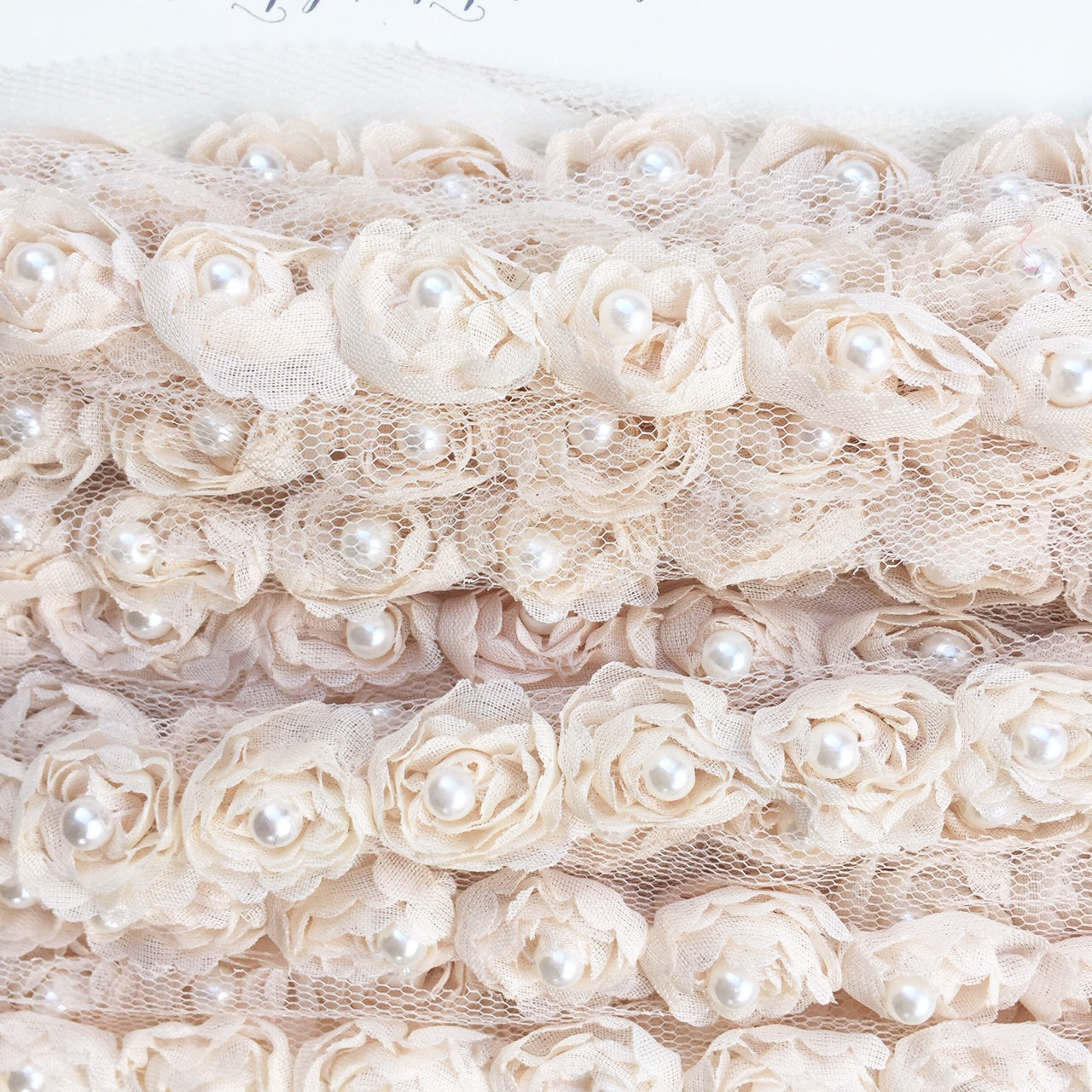 rosebud trim with pearls . vanilla